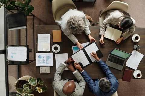 Diverse group of business professionals reviewing documents together